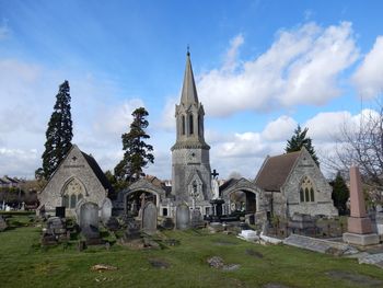 View of cemetery and buildings against sky