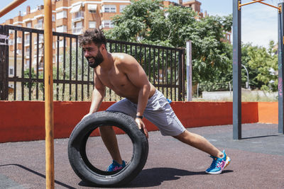 Side view of man exercising in playground