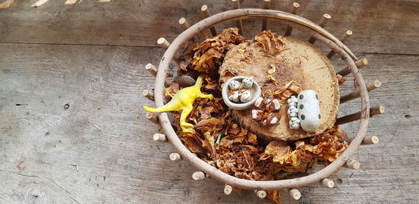 High angle view of toys and dried leaves in basket