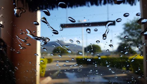 Full frame shot of wet glass window during car wash. 