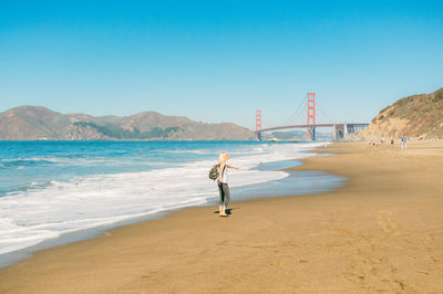 Silhouette of woman standing at beach