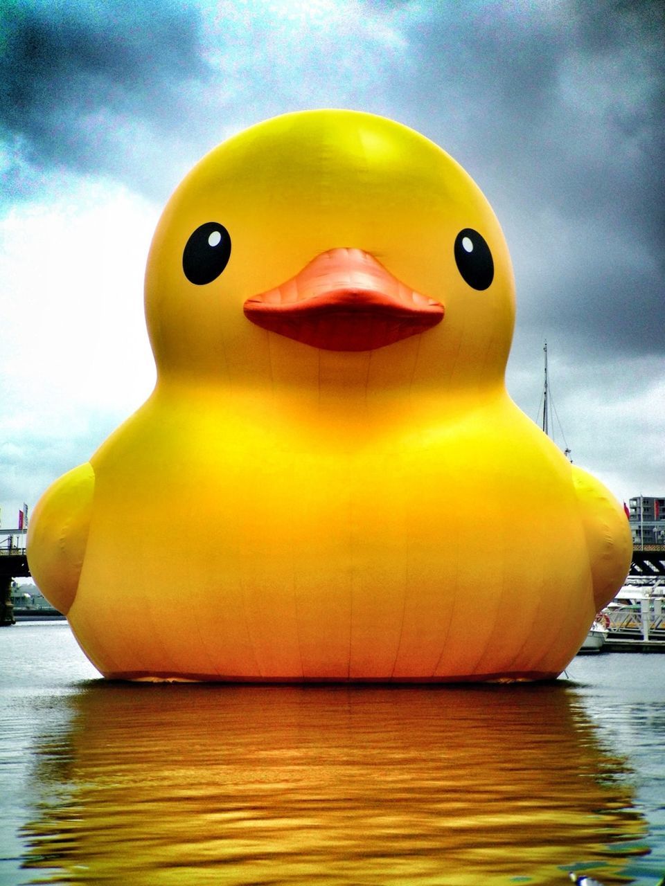 yellow, sky, water, sea, multi colored, toy, close-up, waterfront, outdoors, cloud - sky, animal representation, no people, day, art, cloud, creativity, reflection, nature, childhood, art and craft