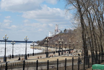 Scenic view of river by city against sky