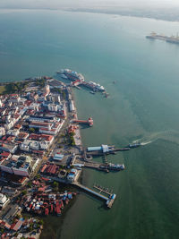 Aerial view ferry arrive penang jetty. background is cruise ship visit penang.