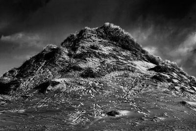 Low angle view of rock formation against sky