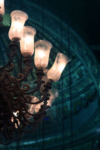 Low angle view of illuminated lamp at night