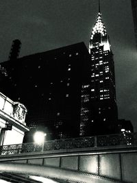 Low angle view of modern building against sky at night