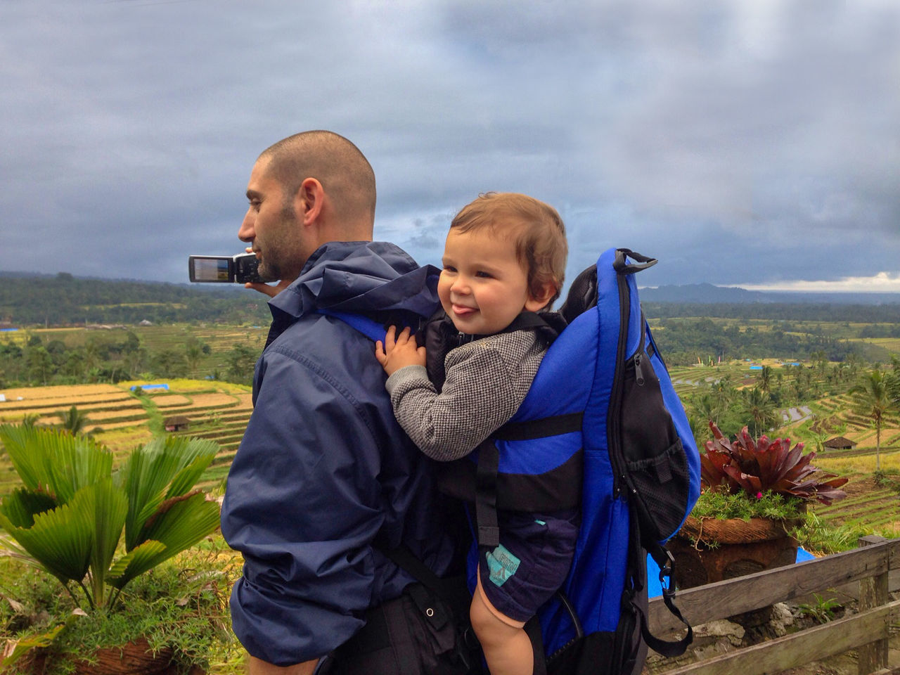 MOTHER AND SON ON FARM AGAINST SKY