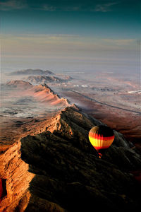 Hot air balloon flying over sea