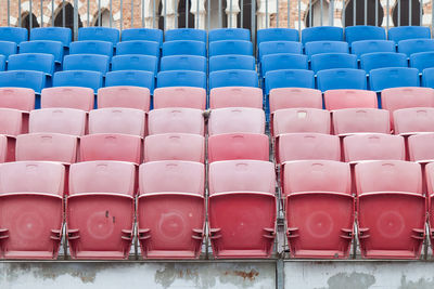 Stack of empty chairs in row