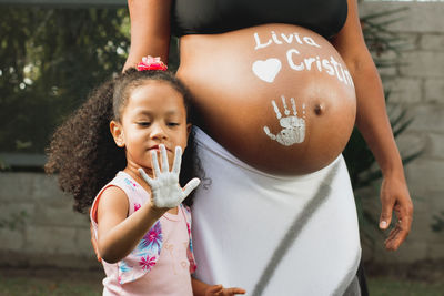 Low angle view of mother holding girl