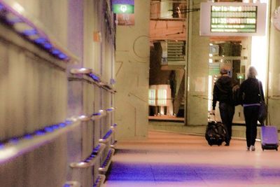 People in illuminated city at night