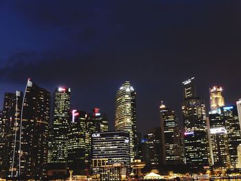 Illuminated buildings against sky at night