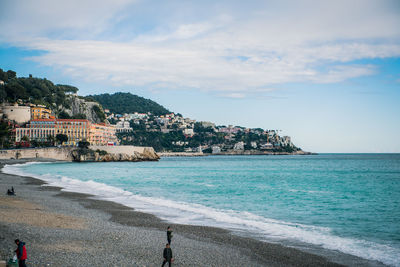 Scenic view of sea and buildings against sky