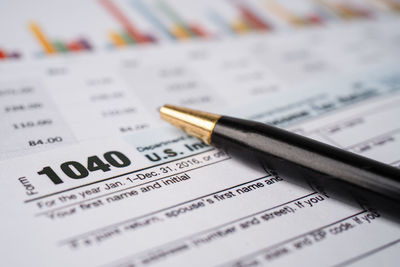 Tax return form 1040 and dollar banknote, u.s. individual income.