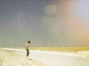 Full length of woman standing on beach