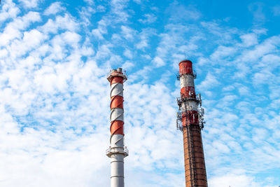 Low angle view of smoke stack against sky