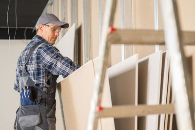 Side view of man working in workshop