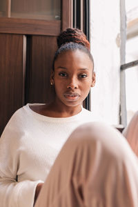 Portrait of young woman at home