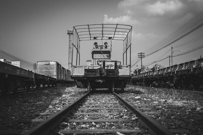 Train on railroad tracks against sky