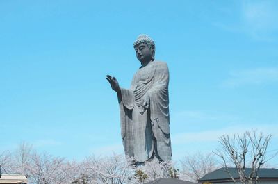 Low angle view of statue against blue sky