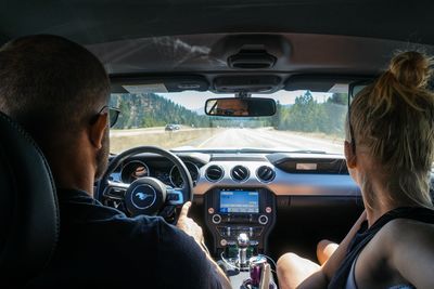 Rear view of man driving car