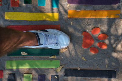 Low section of man standing on wood in city