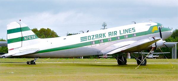 Airplane on airport runway against sky