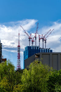 Low angle view of cranes against sky akasaka tokyo japan 