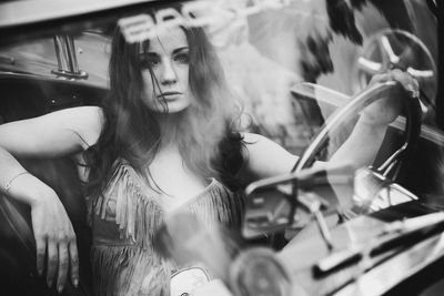 Portrait of beautiful woman sitting in car