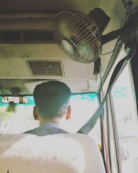 Rear view of a man sitting on road