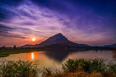 Scenic view of lake against sky during sunset