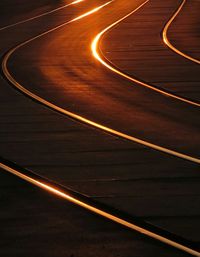 High angle view of railroad tracks on road during sunset