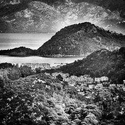 Scenic view of sea and mountains against sky