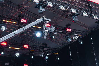 Video camera on the background of the stage spotlights of the music show