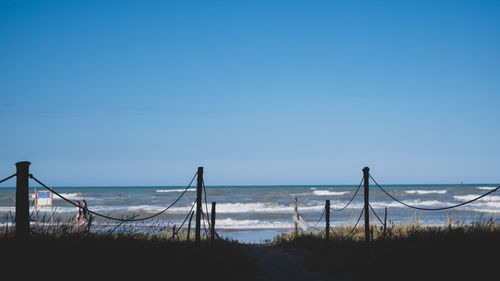 Scenic view of sea against clear blue sky