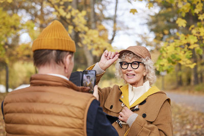 Man photographing woman