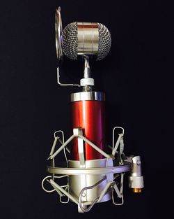 Close-up of microphone against black background