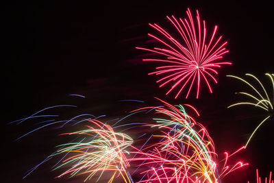 Low angle view of firework display at night