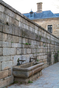 View of old-fashioned faucets on stone wall