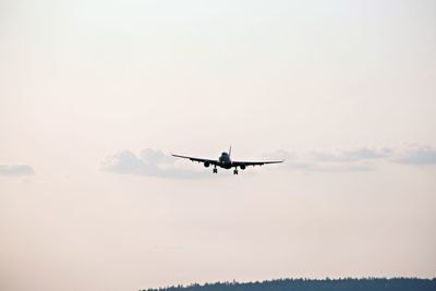 Low angle view of airplane flying against clear sky