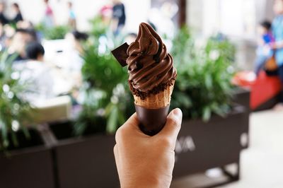 Close-up of hand holding ice cream