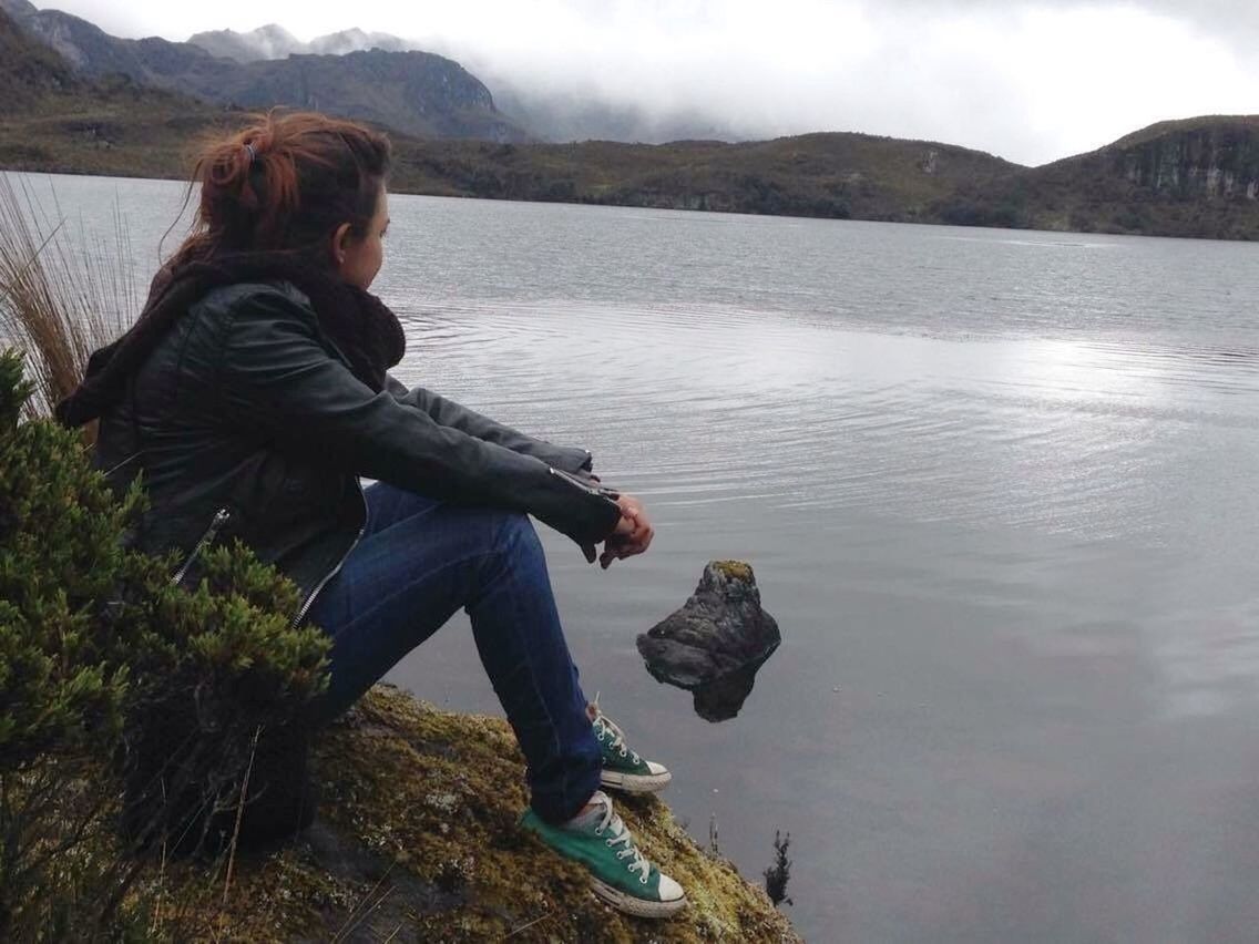 real people, one person, water, nature, lake, casual clothing, full length, outdoors, mountain, day, lifestyles, young women, sitting, beauty in nature, young adult, side view, leisure activity, tree, sky, people