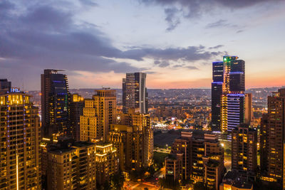 Illuminated cityscape against sky at night