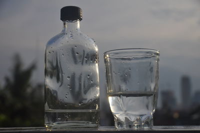 Close-up of water in glass bottle on table