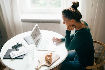 Woman sitting on table