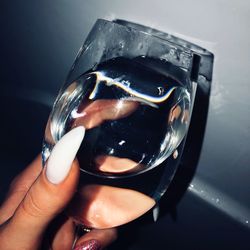 Close-up of hand holding glass of drink