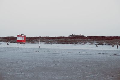 Lifeguard hut on beach against clear sky