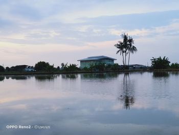 Scenic view of swimming pool by lake against sky