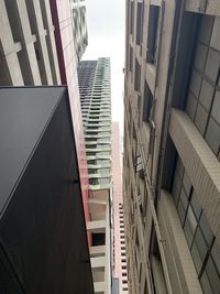 Low angle view of buildings in city against sky